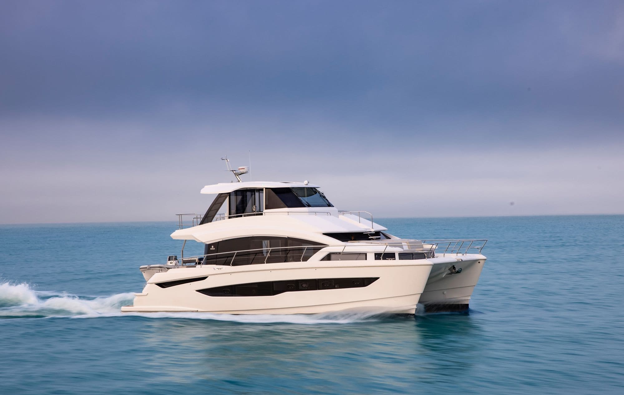 Aquila 54 Yacht running past the camera in profile