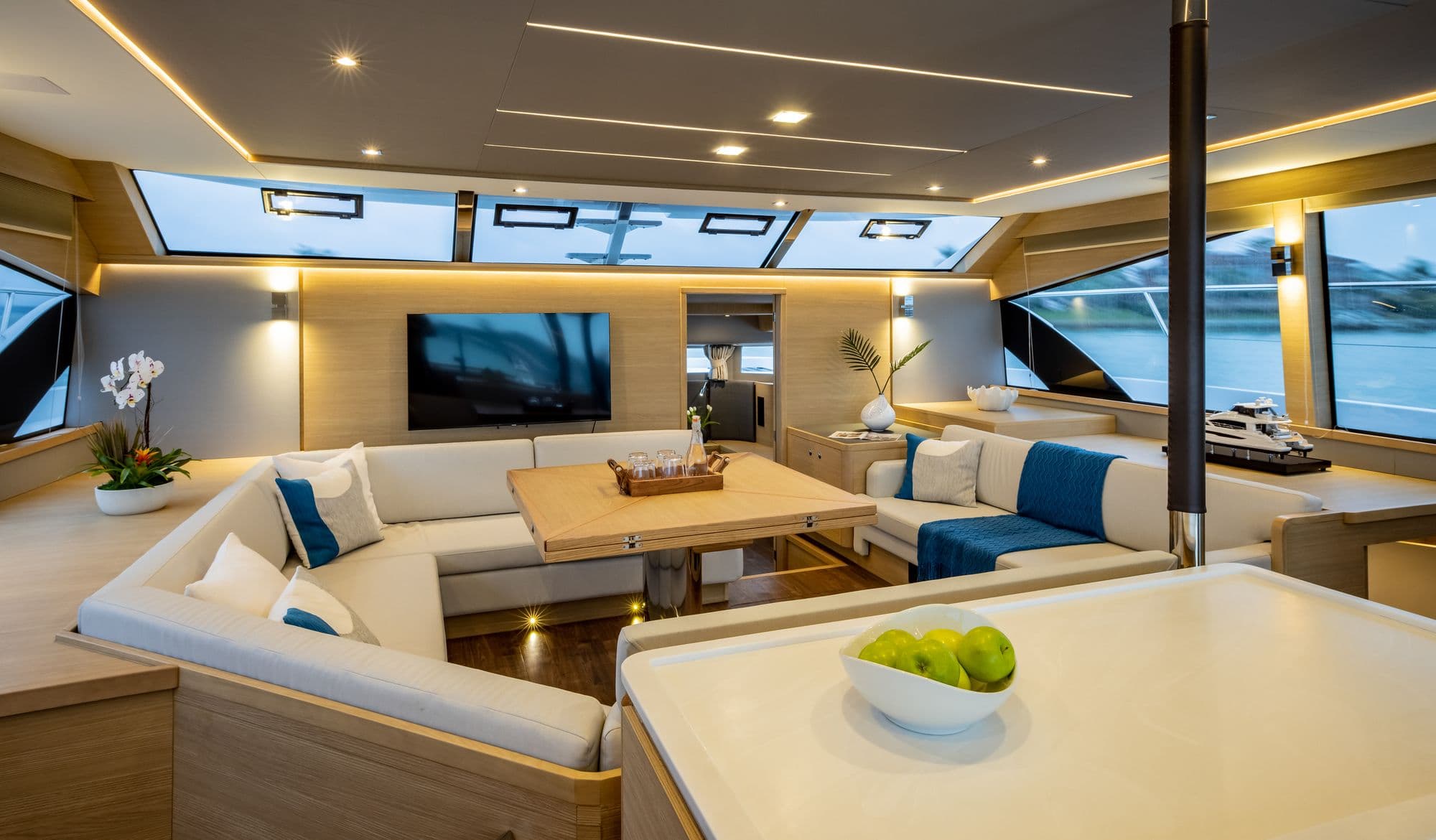 Main salon of the Aquila 54 Yacht with sofas and panoramic windows