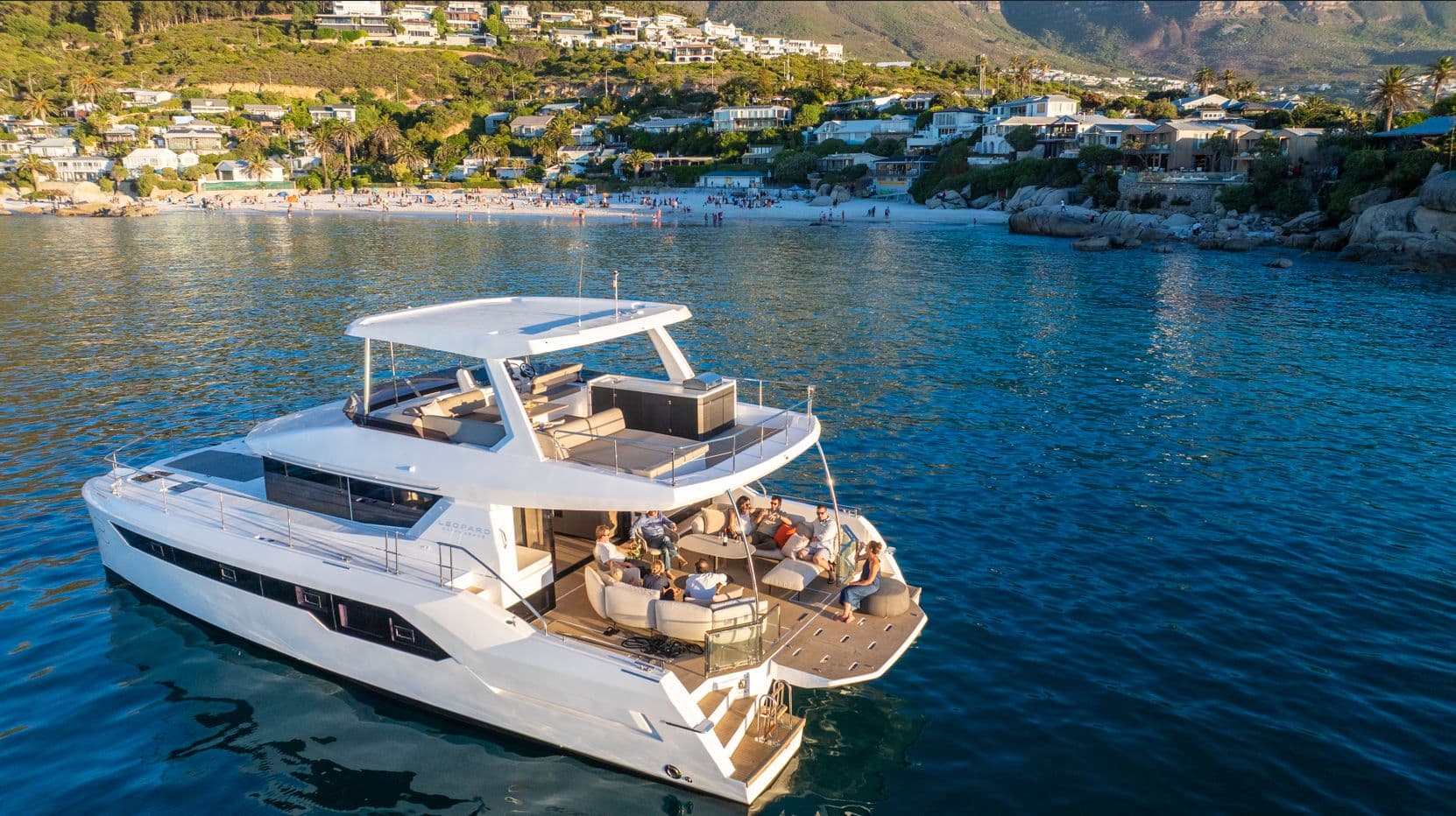 Leopard 53 Powercat at anchor off a hillside town, seen from above the stern quarter