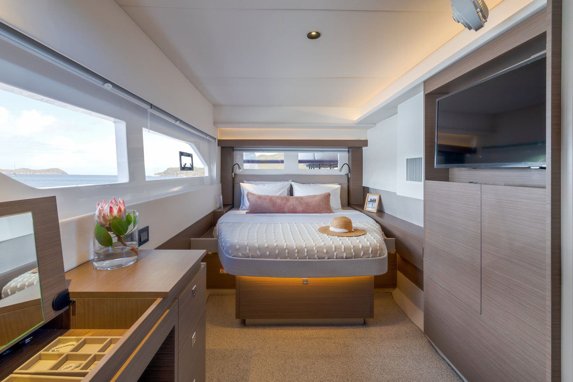 Hull cabin aboard the Leopard 53 Powercat with a double bed and long hull windows