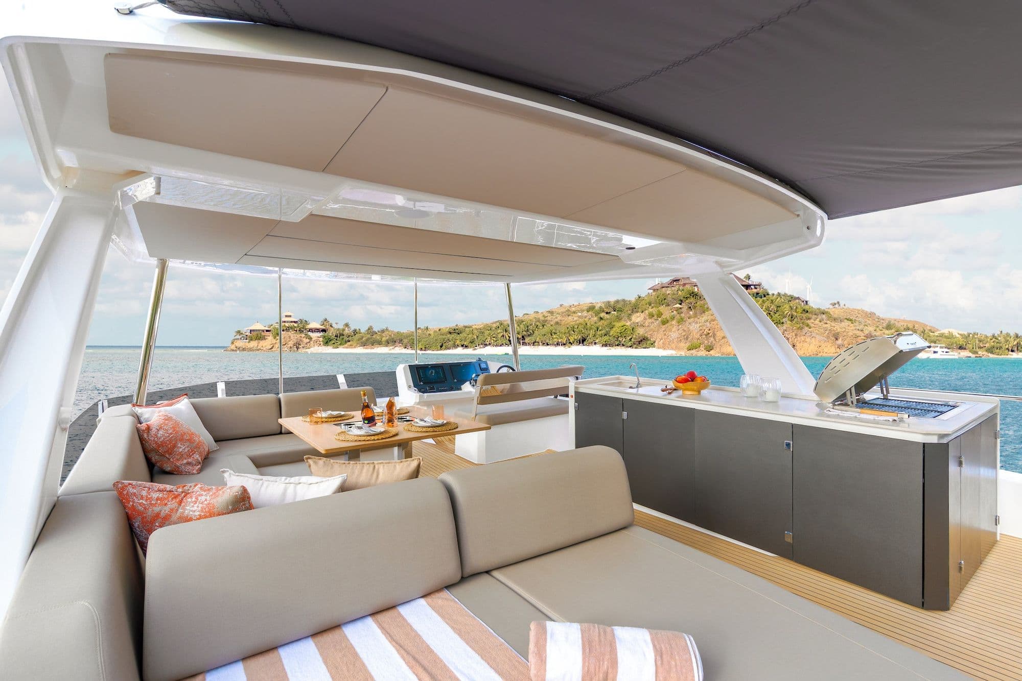 Flybridge of the Leopard 53 Powercat with lounge seating and a wet bar under the hardtop