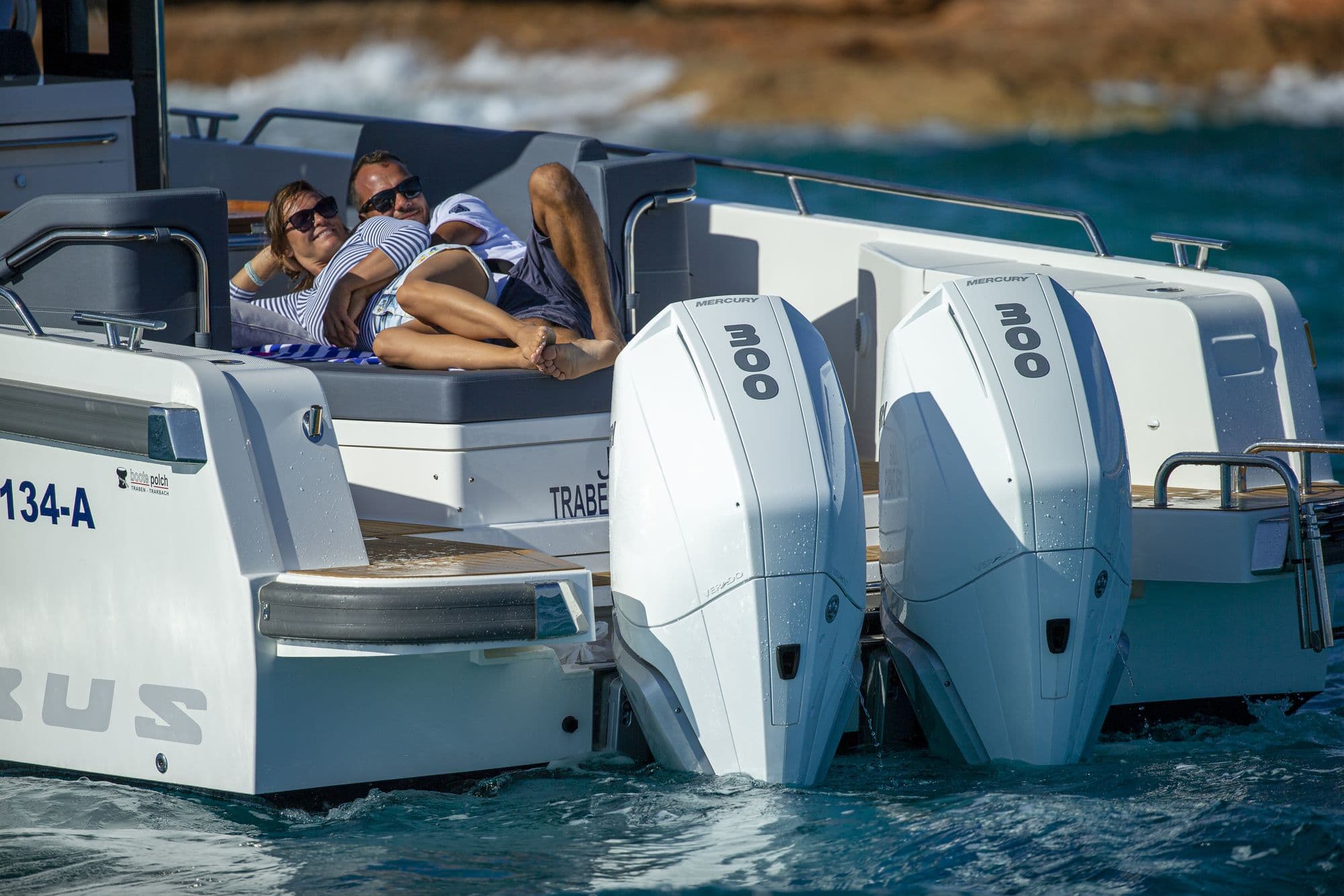 Guests relaxing on the aft deck of the Nimbus T11 above twin outboards