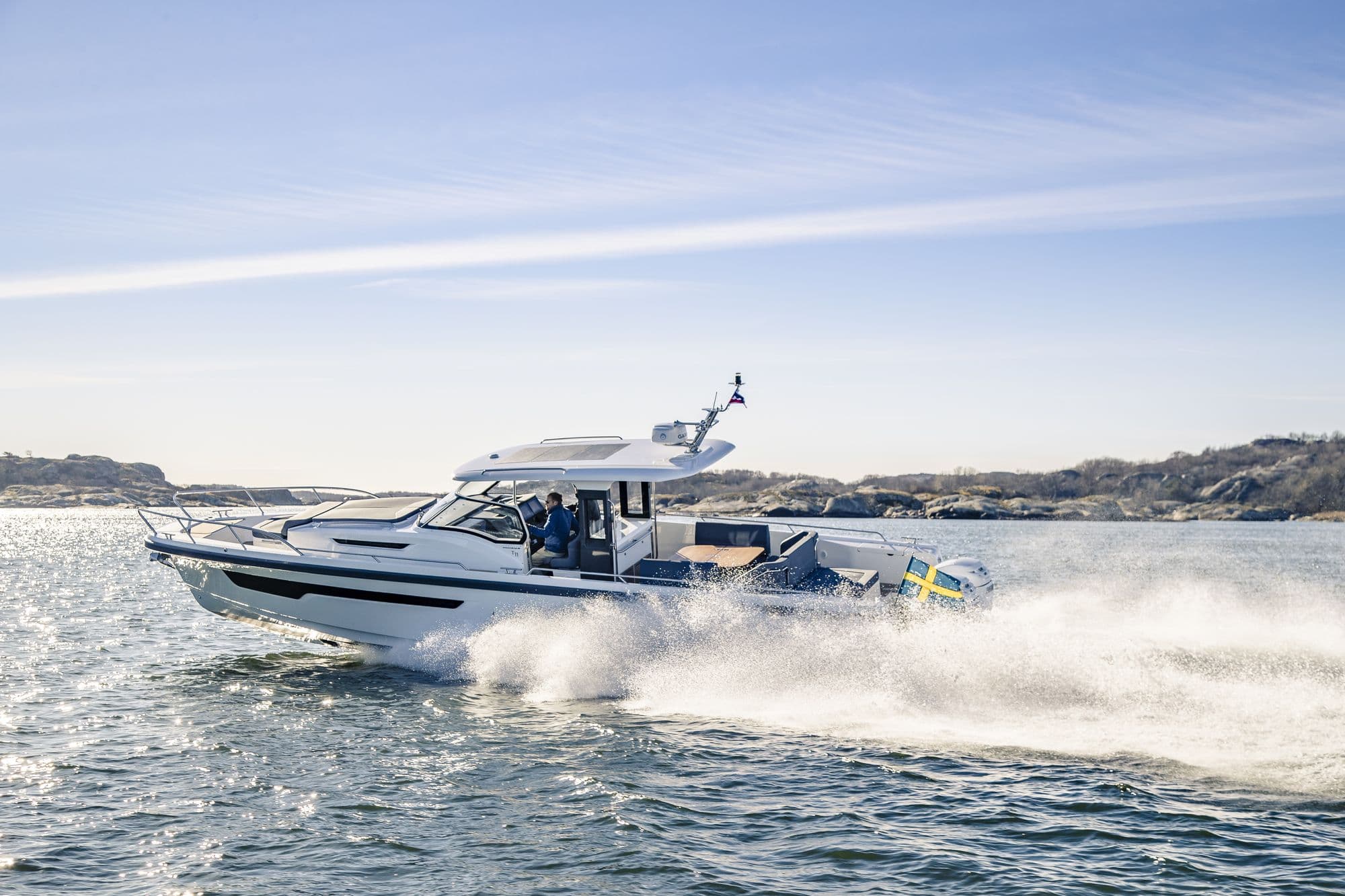 Nimbus T11 running at speed along a coastline