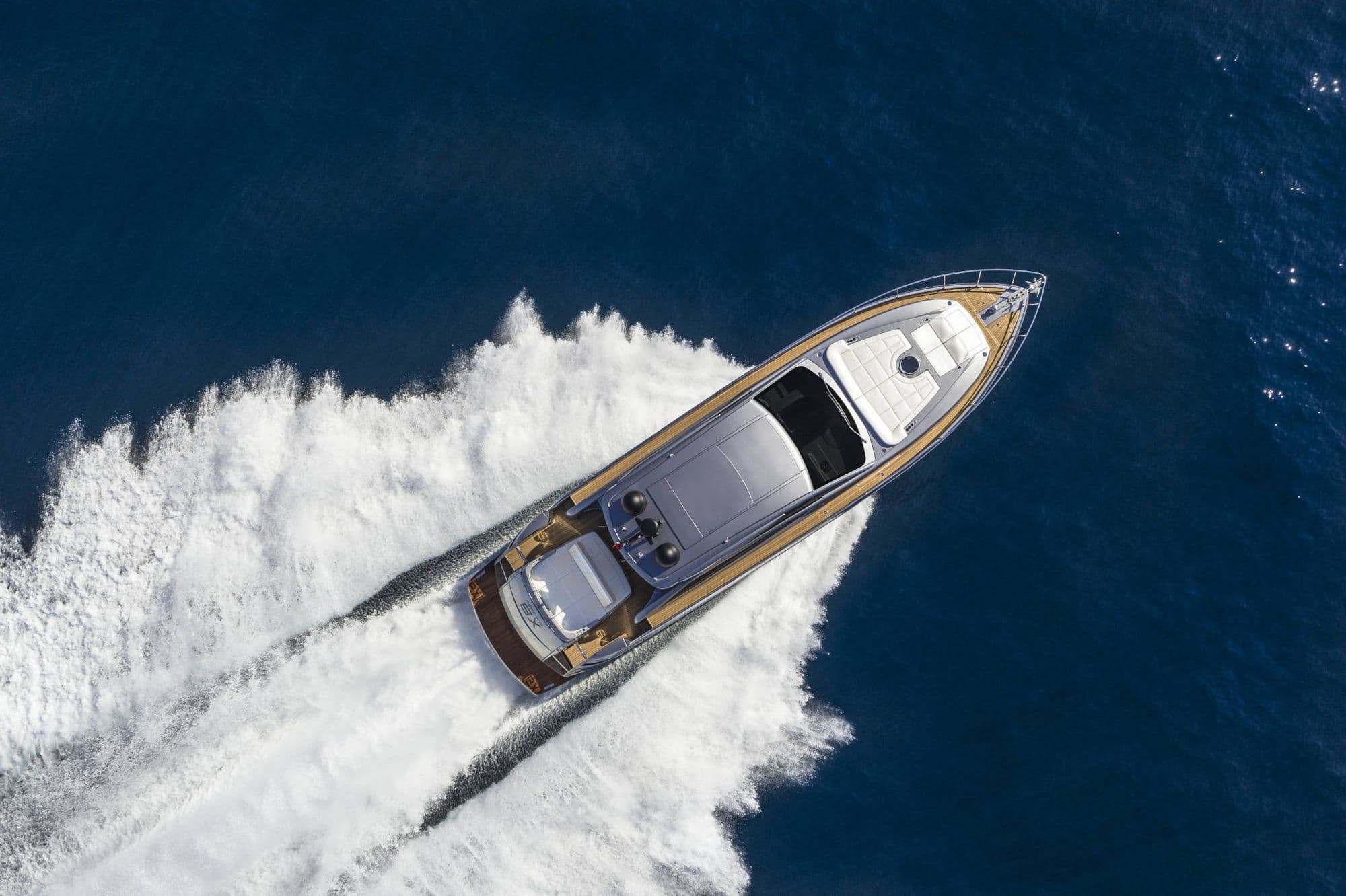 Aerial view of the Pershing 6X at speed showing the deck and sunpads