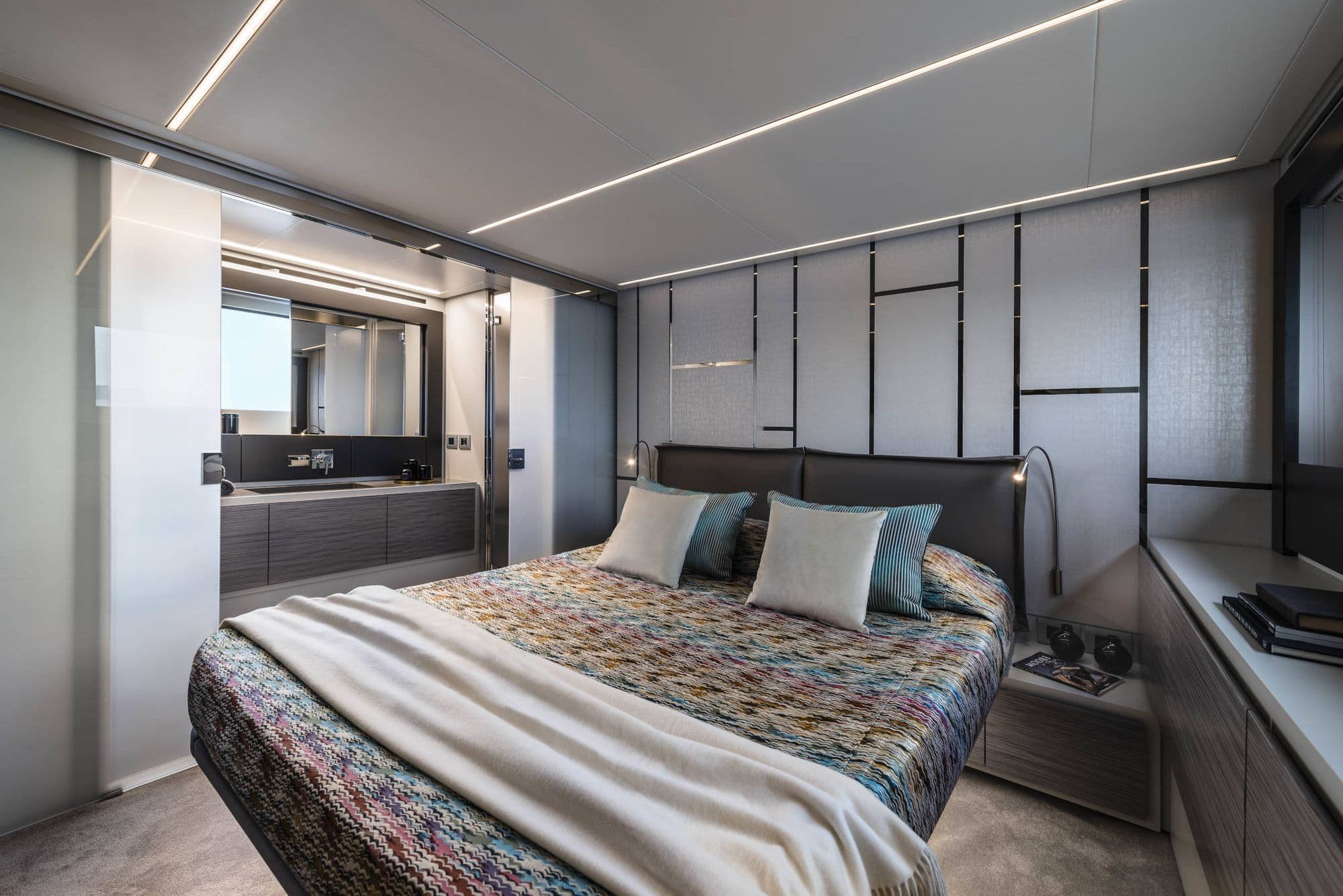 Cabin aboard the Pershing 6X with a double bed and grey wall panels