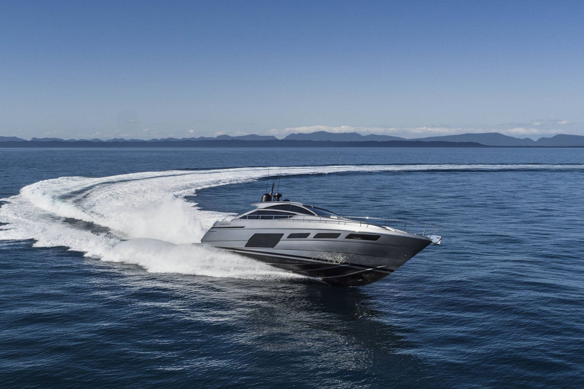 Pershing 6X carving a turn at speed with a long white wake