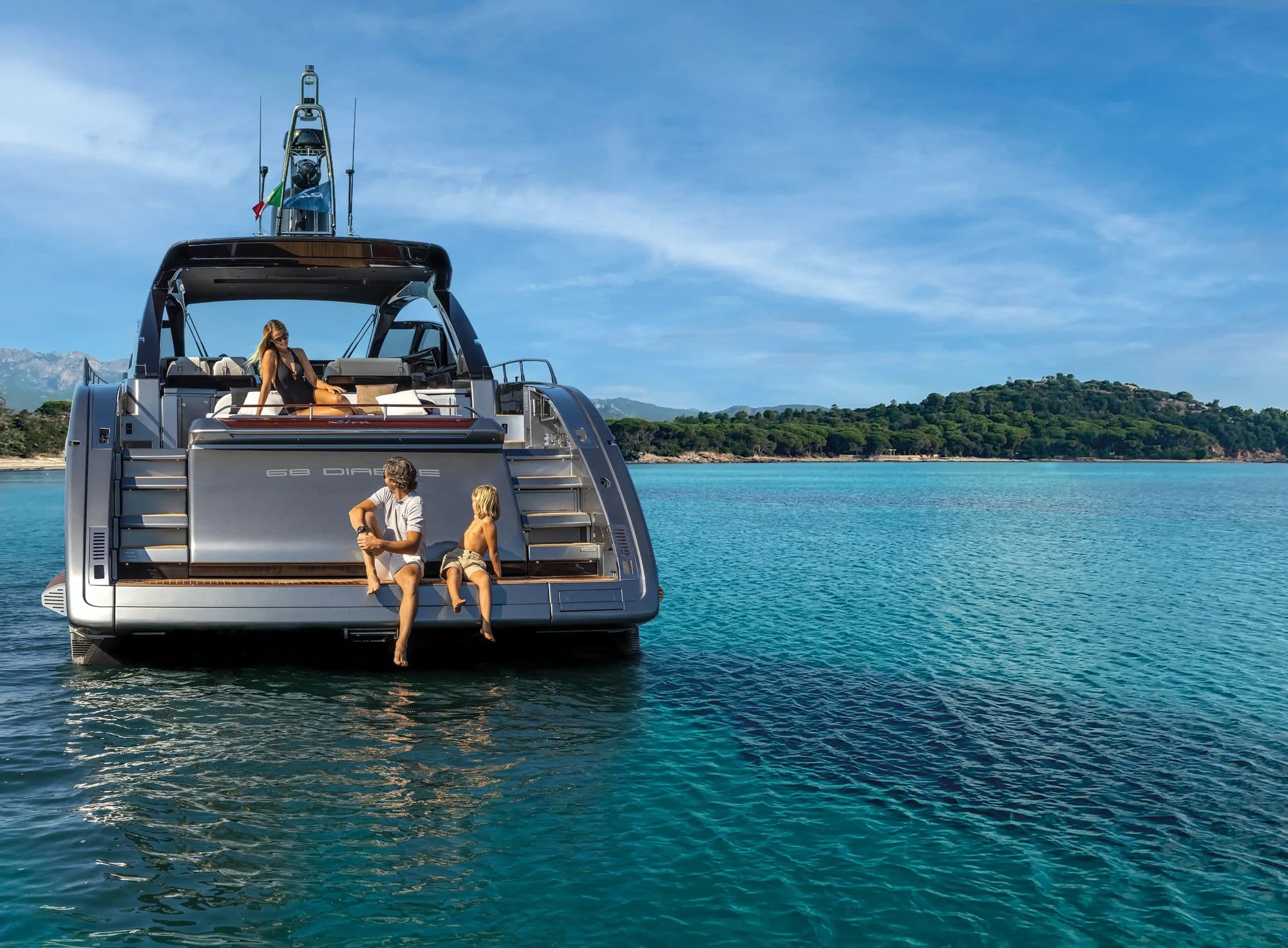 Riva 68' Diable at anchor in clear water with guests on the swim platform