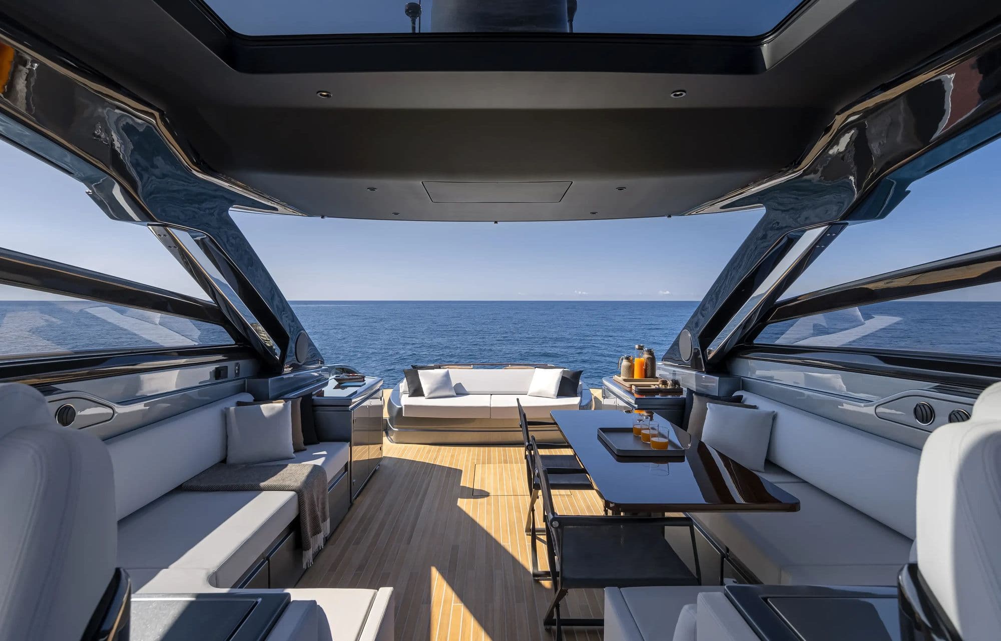 Cockpit and dining area of the Riva 68' Diable under the hardtop