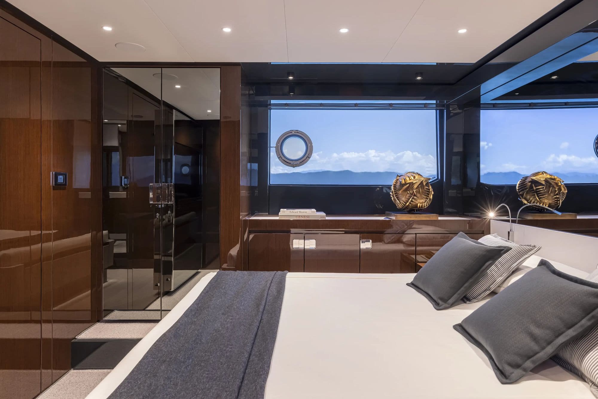 Cabin aboard the Riva 68' Diable with hull windows and dark wood joinery