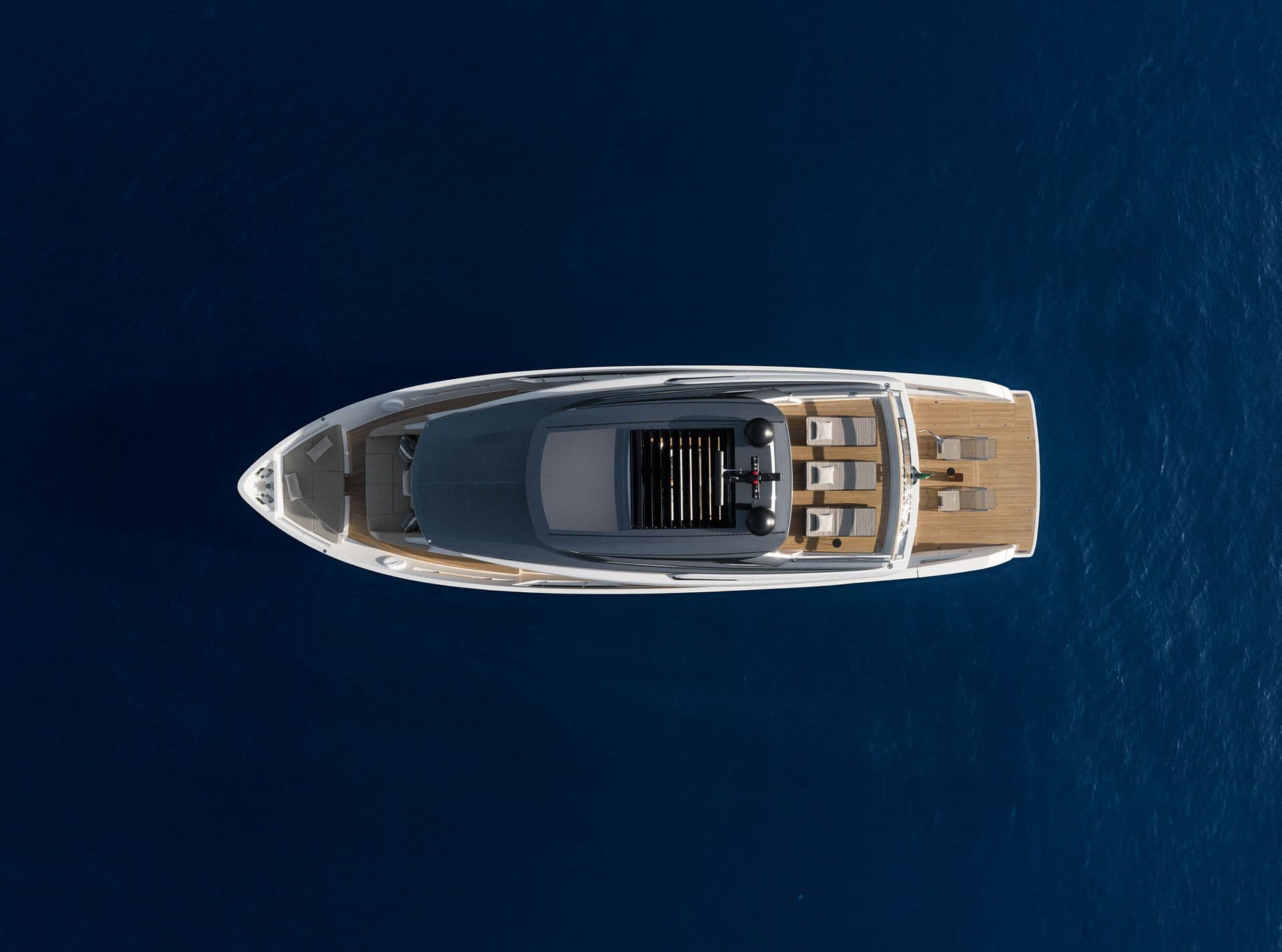 Sanlorenzo SX76 from directly above on dark blue water