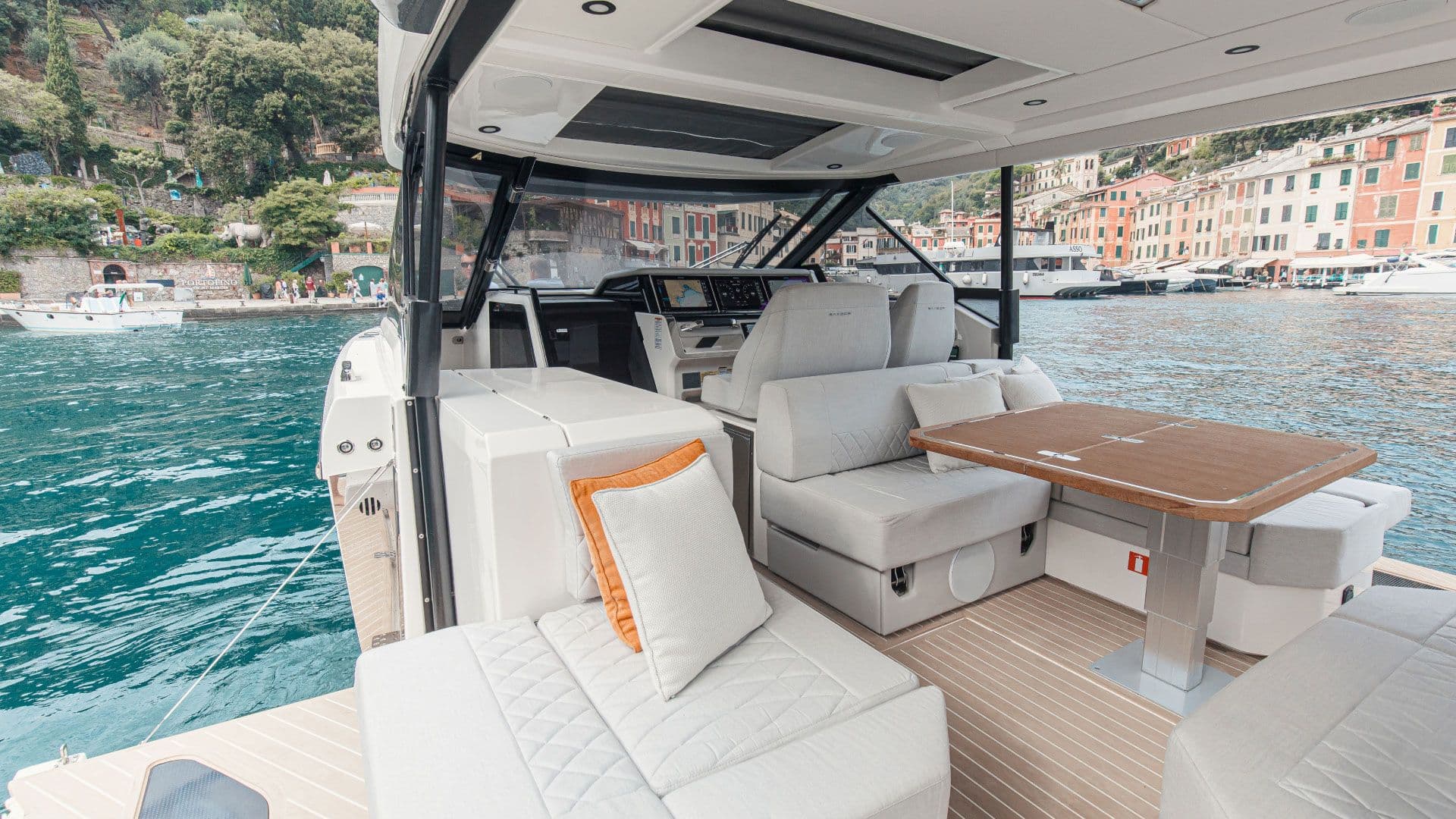 Lounge and table inside the full-beam open wheelhouse of the Saxdor 400 GTO