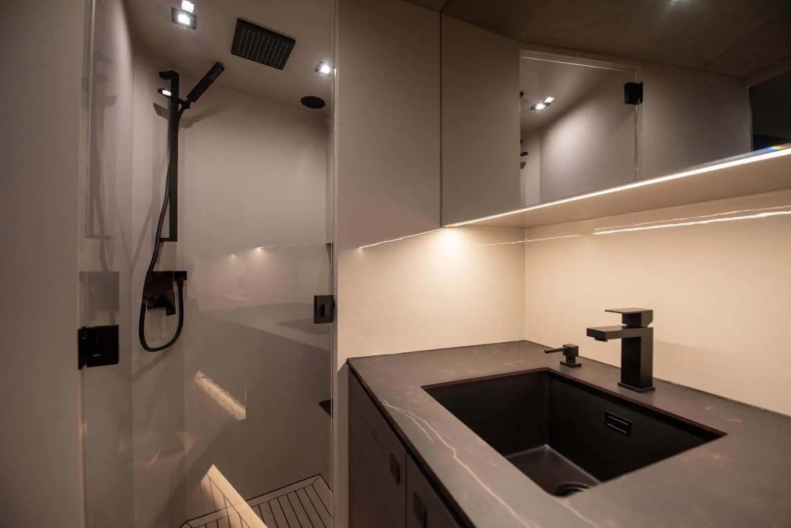 Bathroom aboard the Vanquish VQ58 with a walk-in shower and dark basin