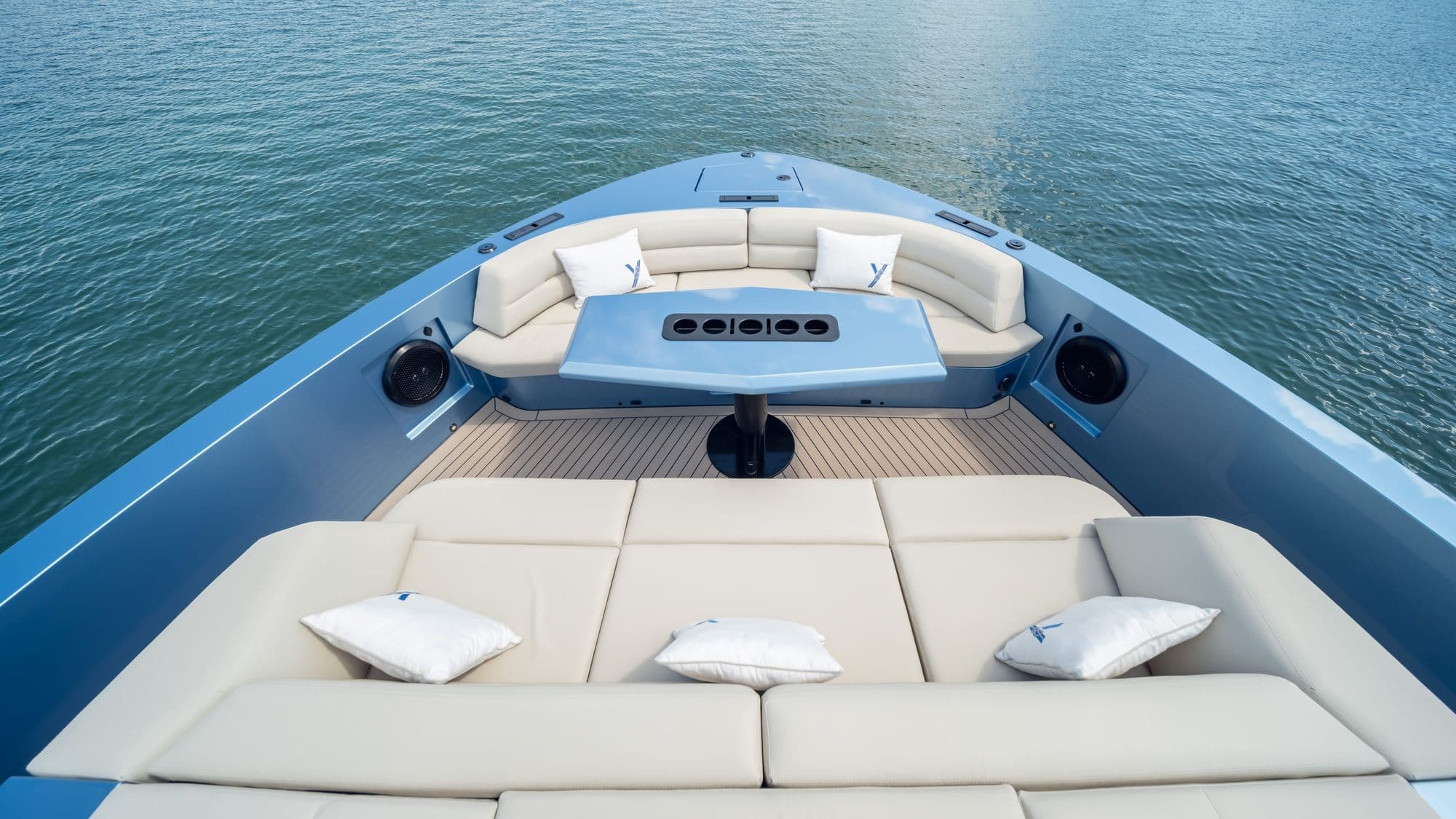 Bow lounge of the Vanquish VQ58 with sunpads and a table