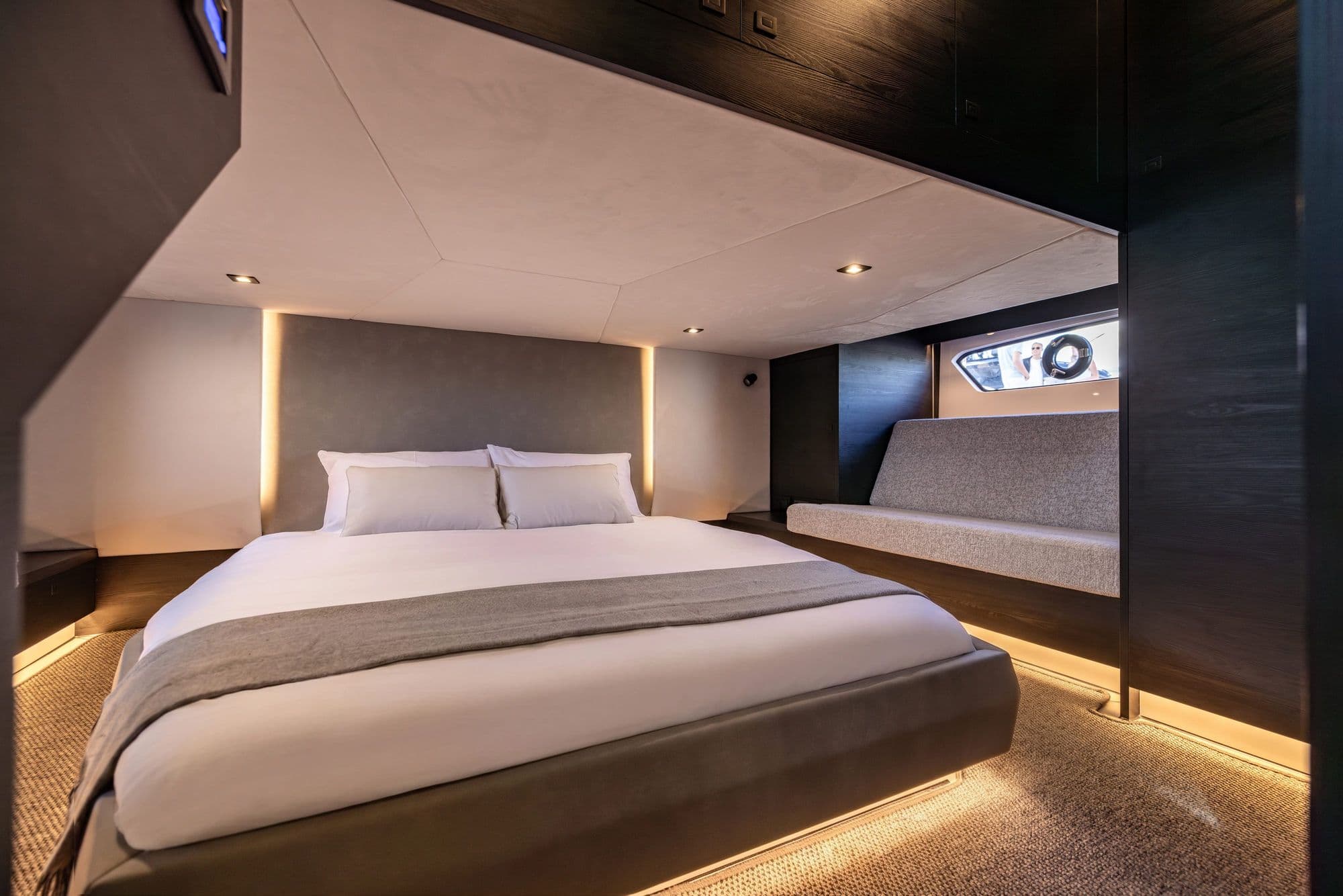 Owner's cabin aboard the Vanquish VQ58 with a large bed and ambient lighting