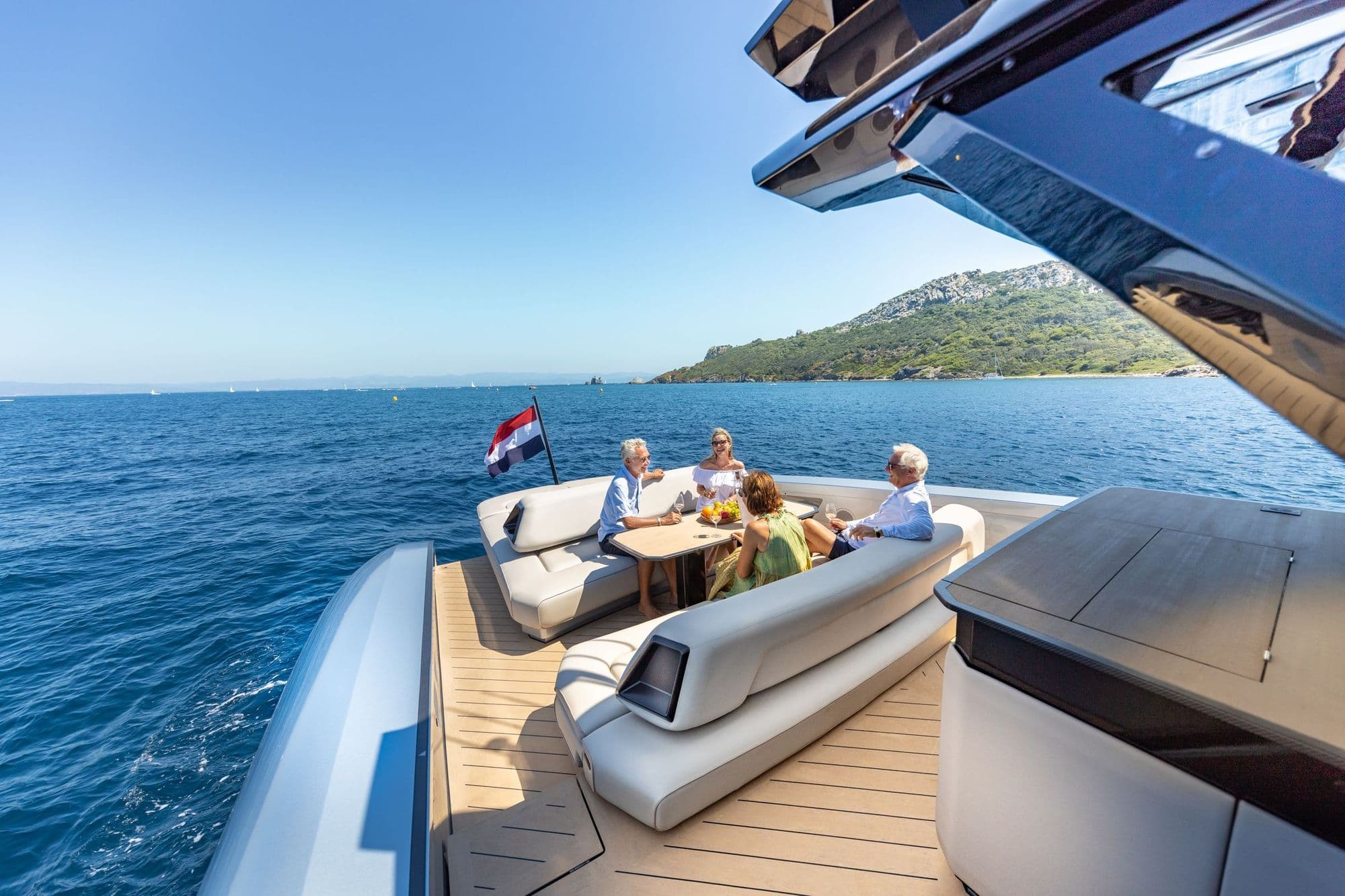 Guests at the aft lounge table of the Wajer 77 under way