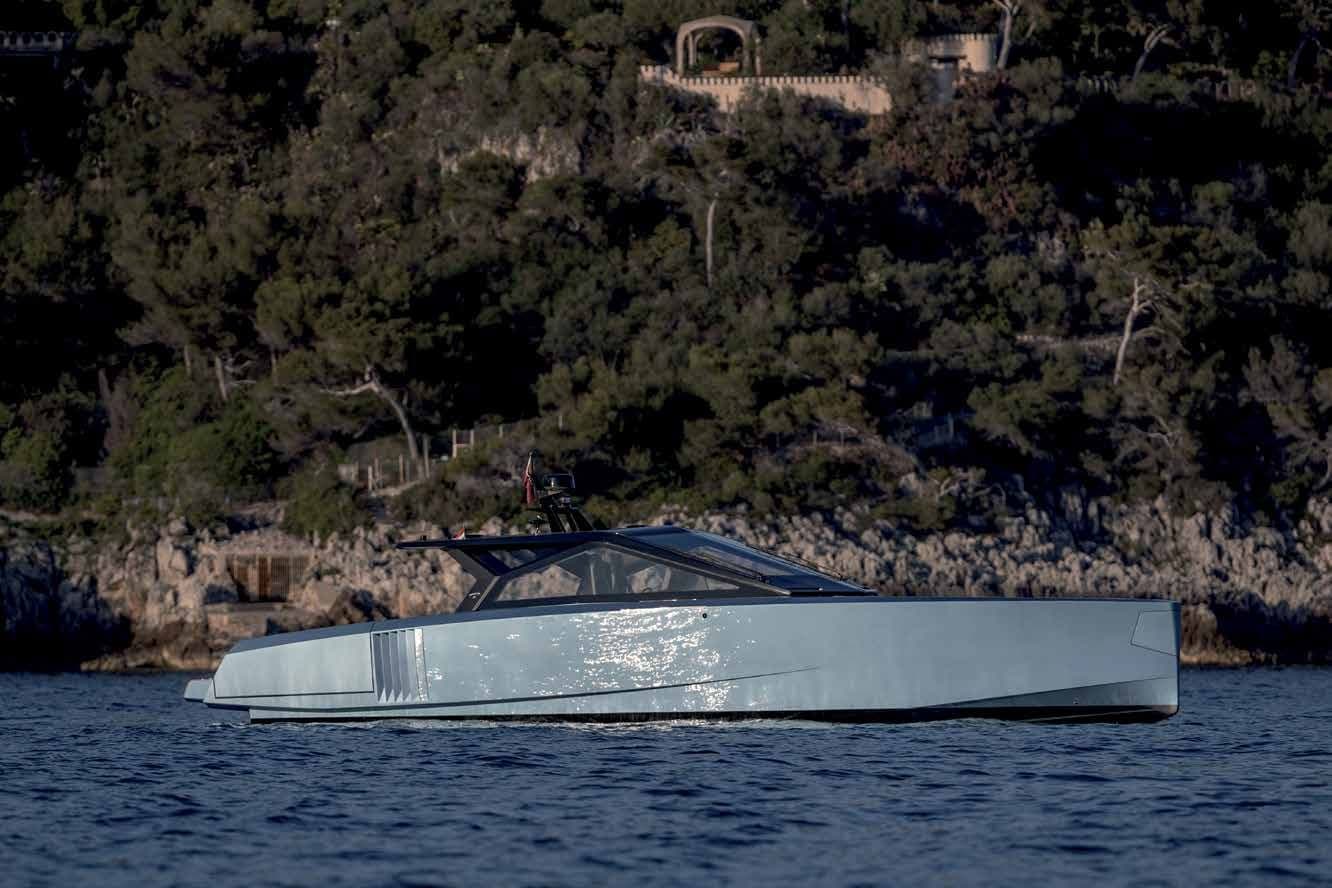 Wally wallypower58 in profile at anchor off a wooded shore