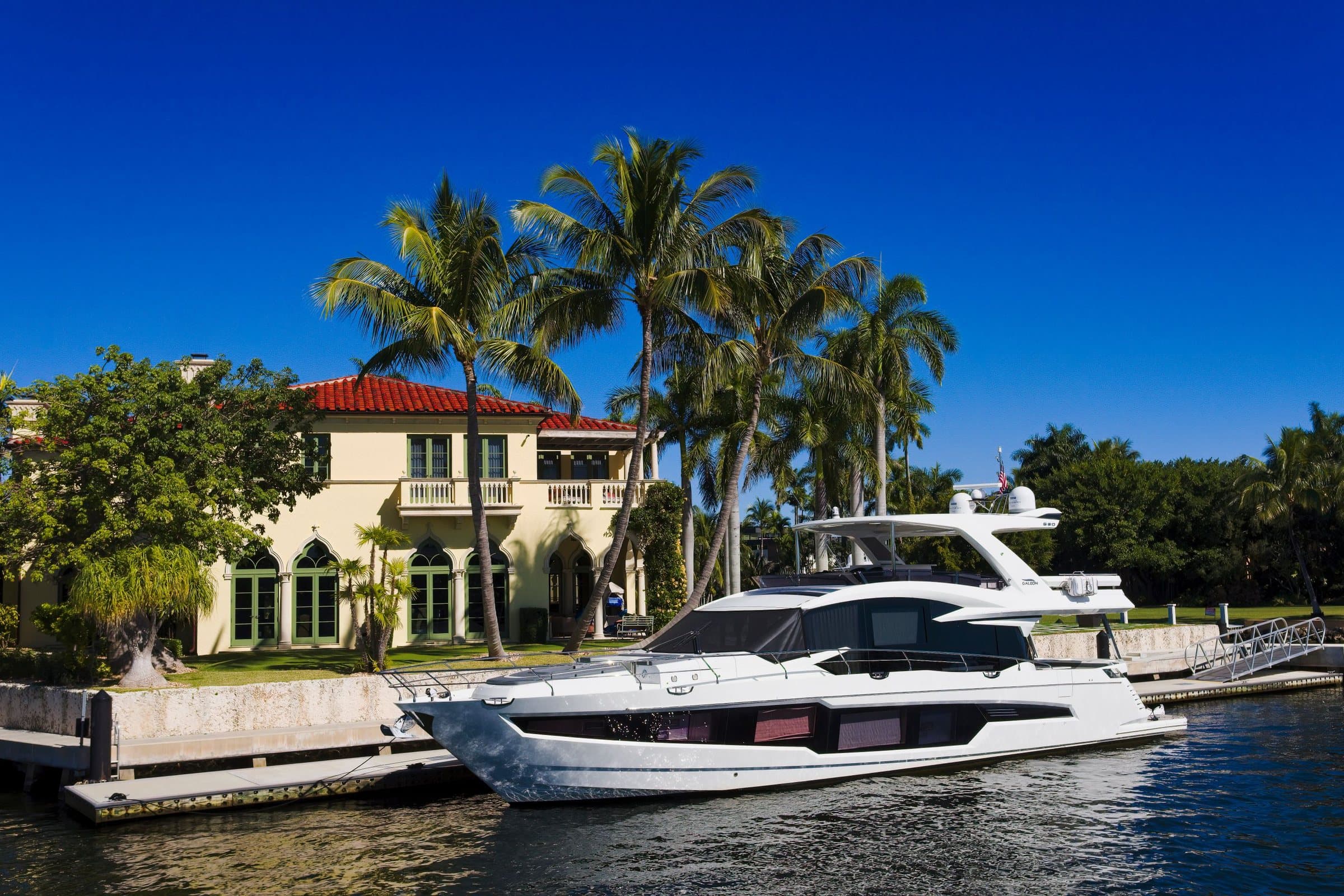 Modern motor yacht docked at a Fort Lauderdale waterfront home