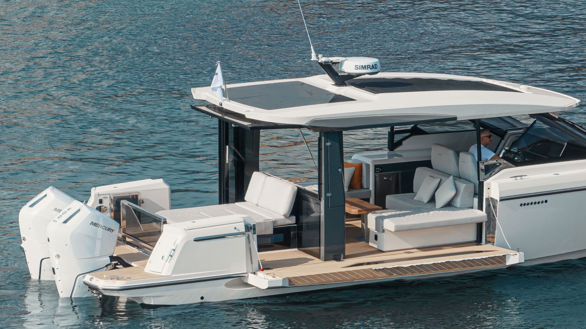 Saxdor 400 GTO at anchor with its side terrace folded down to the water