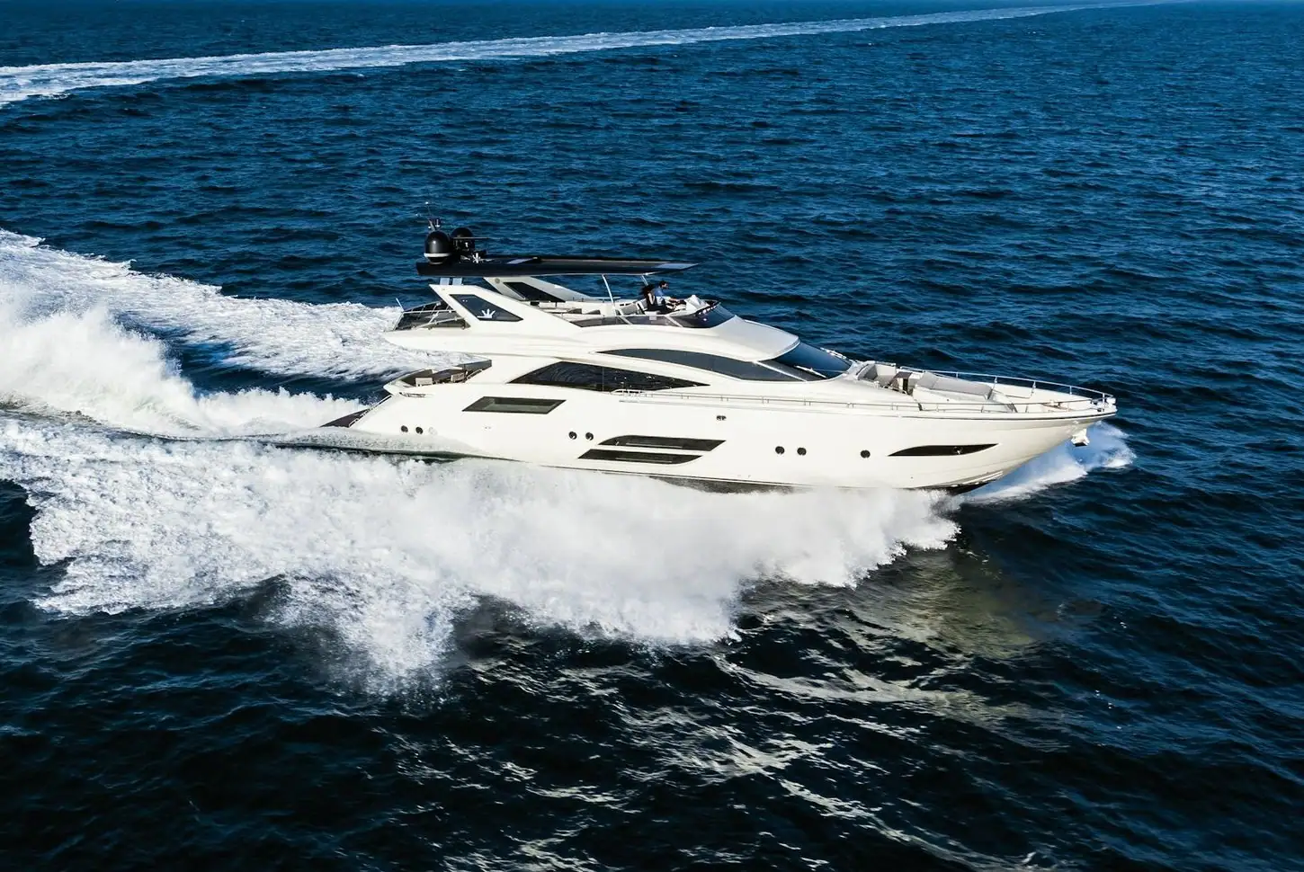 Modern flybridge motor yacht at speed, sell your yacht with a free valuation